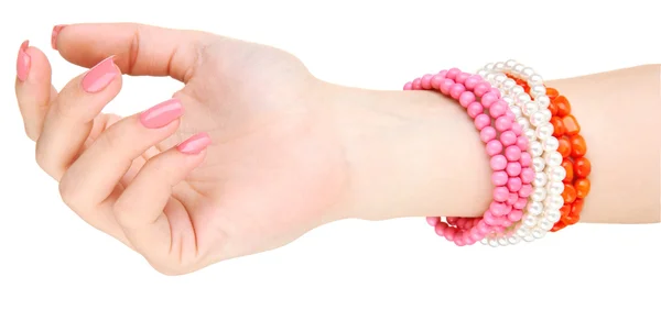 Female hand with pink manicure and bright bracelets, isolated on white — Stock Photo, Image