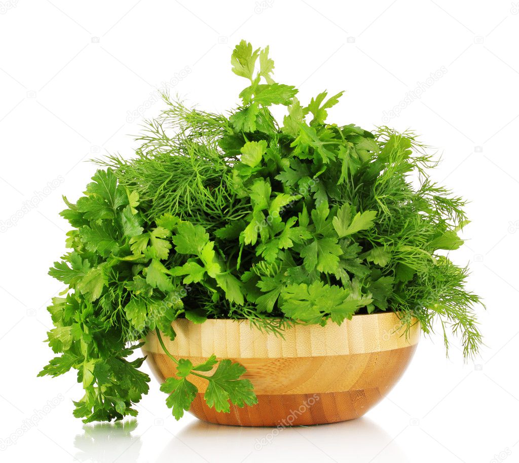 Wooden plate with parsley and dill isolated on white