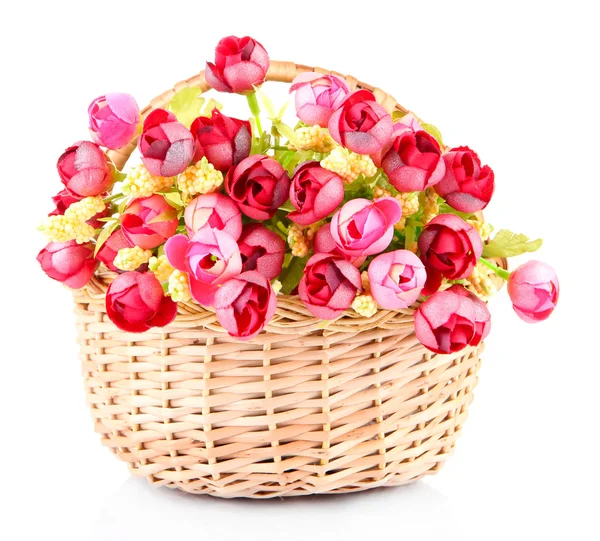 Bouquet of beautiful artificial flowers in wicker basket, isolated on white — Stock Photo, Image