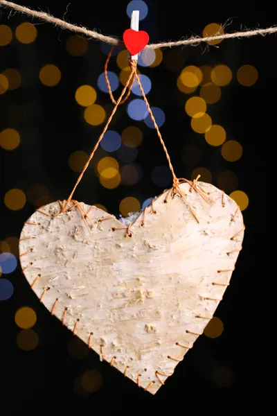 Decorative heart on rope on shiny background — Stock Photo, Image