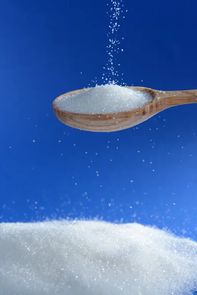 Sugar on blue background — Stock Photo, Image