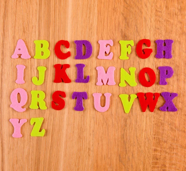 English alphabet on wooden background — Stock Photo, Image