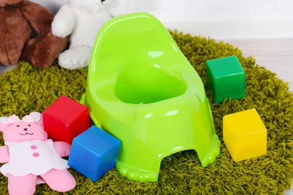 Green potty on home interior background — Stock Photo, Image