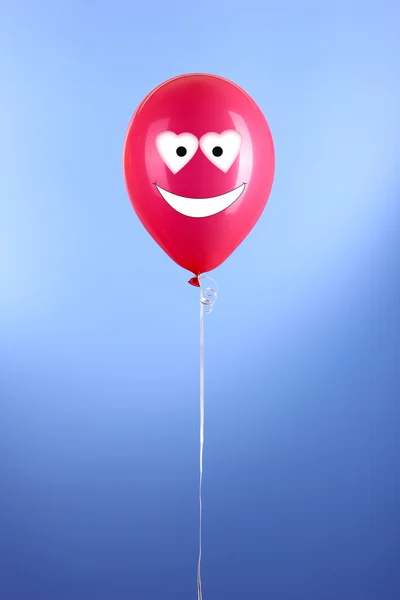 Vermelho um balão no fundo azul — Fotografia de Stock