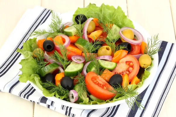 Salada fresca em placa na mesa de madeira — Fotografia de Stock