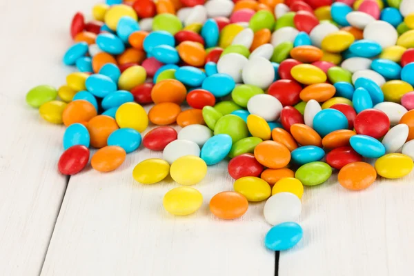 Colorful candies on white wooden background — Stock Photo, Image