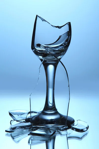Gebroken wijnglas op blauwe achtergrond — Stockfoto