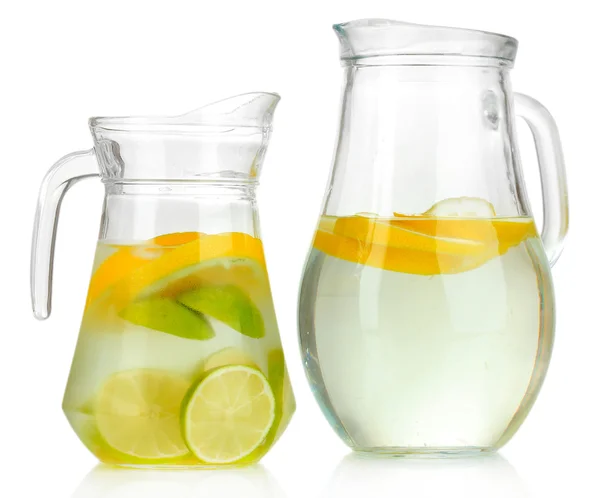 Cold water with lime, lemon and ice in pitchers isolated on white — Stock Photo, Image