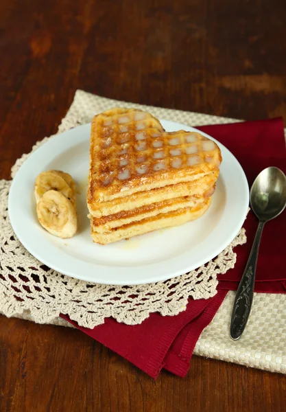 Sweet Belgium waffles with banana, on wooden table background — Stock Photo, Image