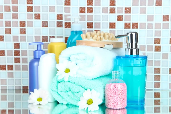 Cosmetics and bath accessories on mosaic tiles background — Stock Photo, Image