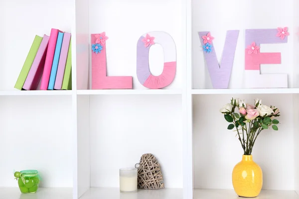 White shelves decorated with handmade knit word — Stock Photo, Image