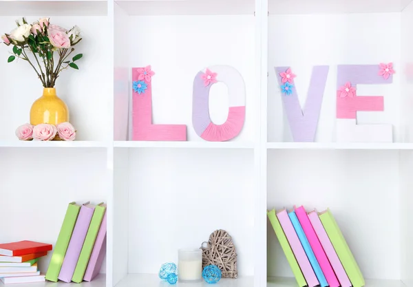 White shelves decorated with handmade knit word — Stock Photo, Image