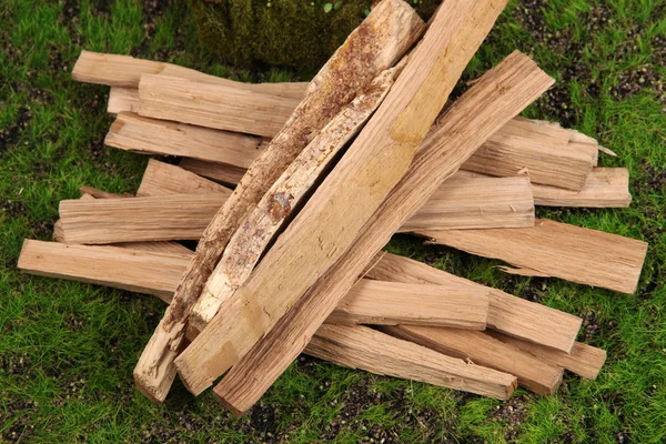 Stack of firewood on grass close up — Stock Photo, Image