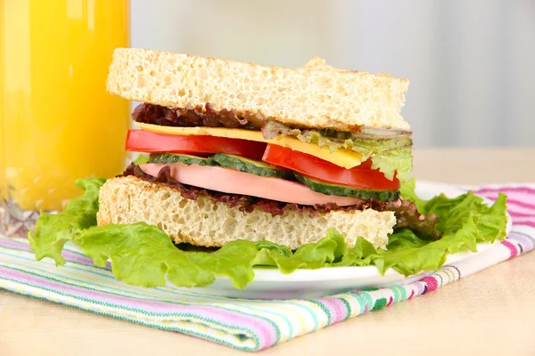 Fresh and tasty sandwich on plate on table on light background — Stock Photo, Image