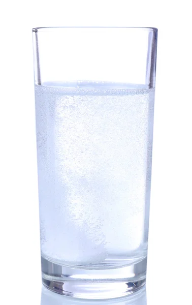 Glass with efervescent tablet in water with bubbles isolated on white — Stock Photo, Image