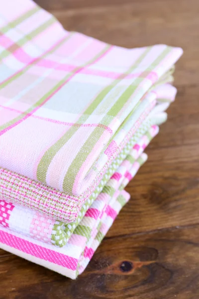 Kitchen towels on wooden background — Stockfoto