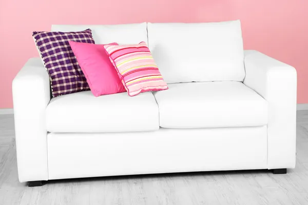 White sofa in room on pink background — Stock Photo, Image