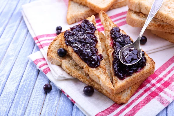 Delicious toast with jam on table close-up — Stock Photo, Image