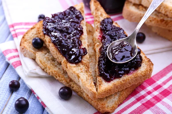 Delicious toast with jam on table close-up — Stock Photo, Image