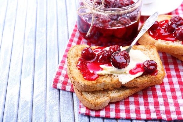 Delicious toast with jam on table close-up — Stock Photo, Image