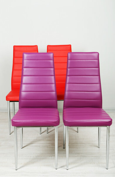 Modern color chairs on wall background