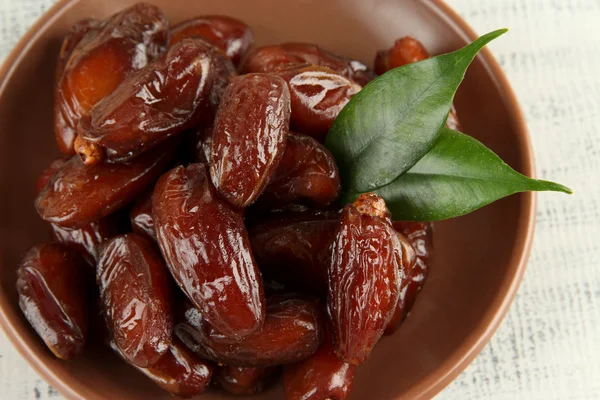 Dried dates on plate on wooden background — Stock Photo, Image