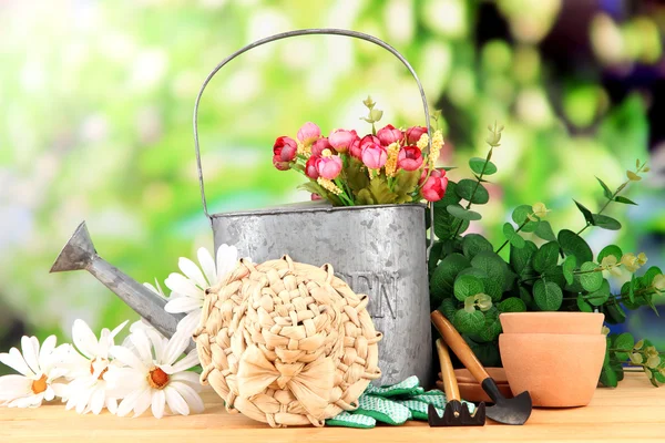 Εργαλεία κηπουρικής και λουλούδια στο ξύλινο τραπέζι, σε εξωτερικούς χώρους — Φωτογραφία Αρχείου