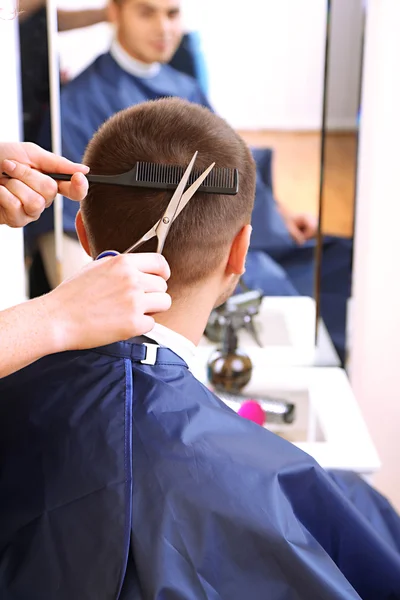 Beautiful girl hairdresser cut guy in beauty salon — Stock Photo, Image