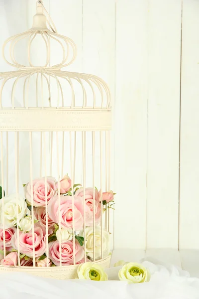 Beautiful decorative cage with beautiful flowers — Stock Photo, Image