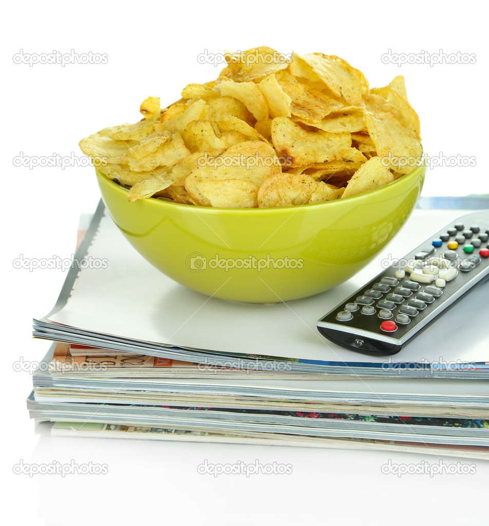 Chips in bowl and TV remote isolated on white