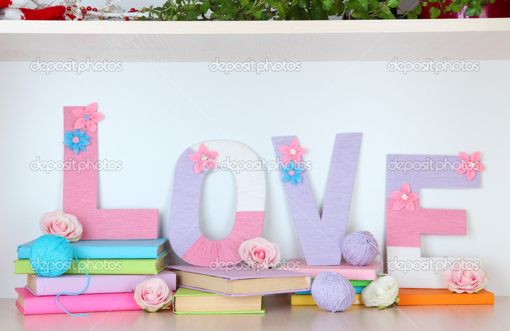 Shelf decorated with handmade knit letter