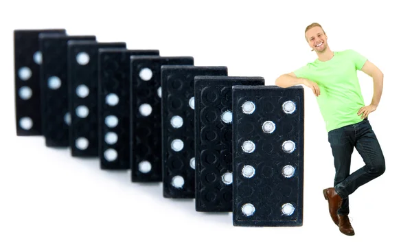 Jeune homme avec dominos isolé sur blanc — Photo