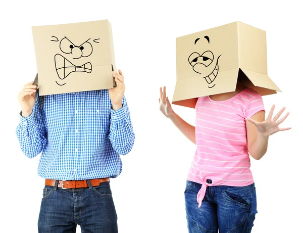 Couple with cardboard boxes on their heads isolated on white — Stock Photo, Image