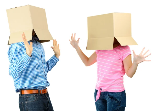 Couple with cardboard boxes on their heads isolated on white — Stock Photo, Image