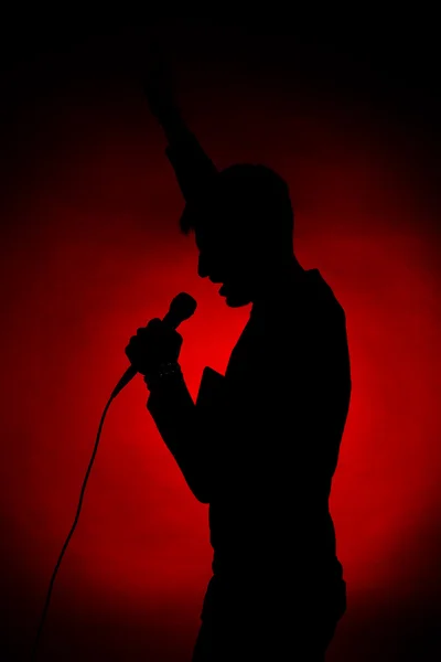 Musician silhouette on dark color background — Stock Photo, Image