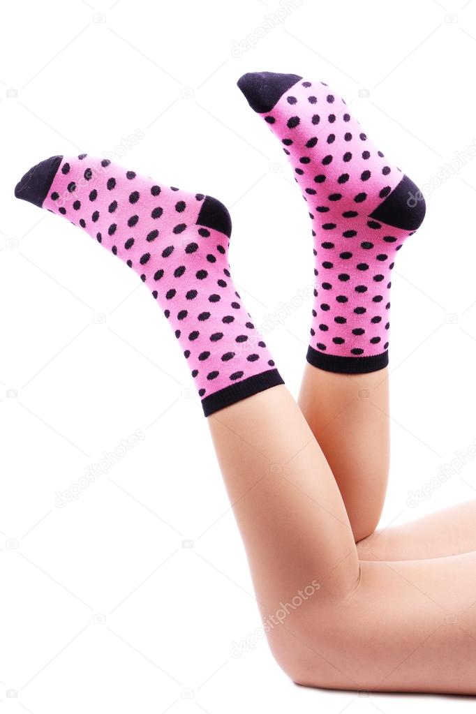 Female legs in colorful socks, isolated on white