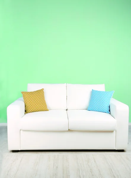 White sofa in room on green background — Stock Photo, Image