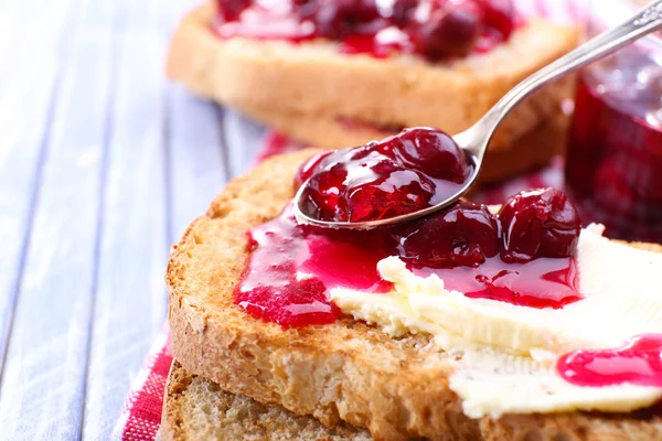 Delicious toast with jam on table close-up — Stock Photo, Image