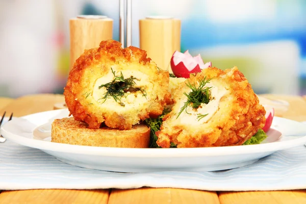 Chicken Kiev on croutons with mashed potatoes, on wooden table, on bright background — Stock Photo, Image