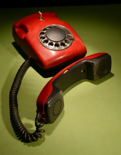 Red retro telephone on dark color background — Stock Photo, Image