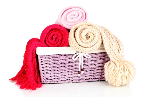 Warm knitted scarves in basket isolated on white — Stock Photo, Image