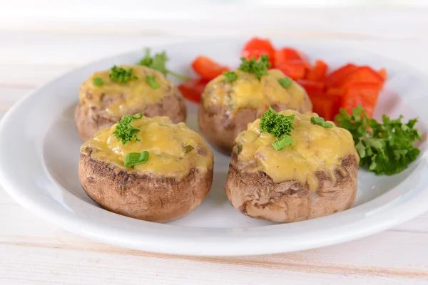 Stuffed mushrooms on plate on table on light background — Stock Photo, Image