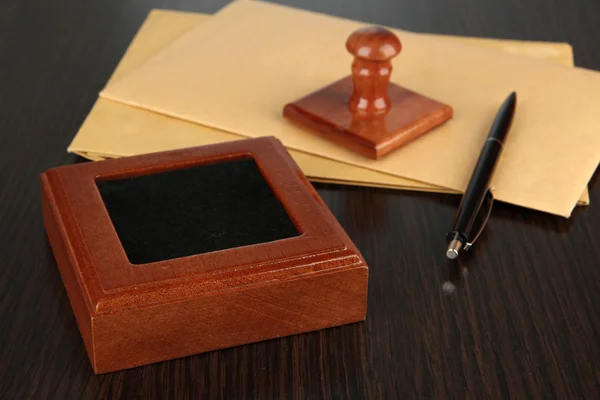 Wooden stamp with documents on table — Stock Photo, Image