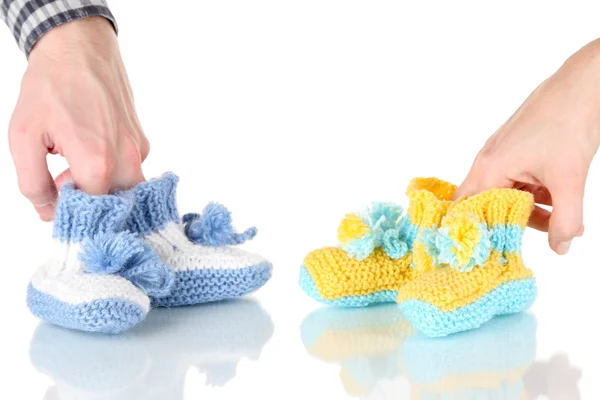 Hands with crocheted booties for baby, isolated on white — Stock Photo, Image