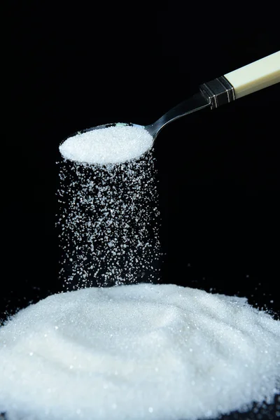 Sugar isolated on black — Stock Photo, Image