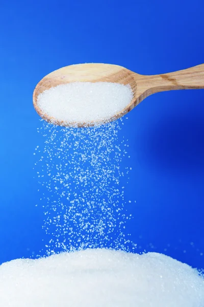 Sugar on blue background — Stock Photo, Image