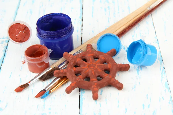 Rueda de cerámica hecha a mano y pinturas de color en mesa de madera —  Fotos de Stock