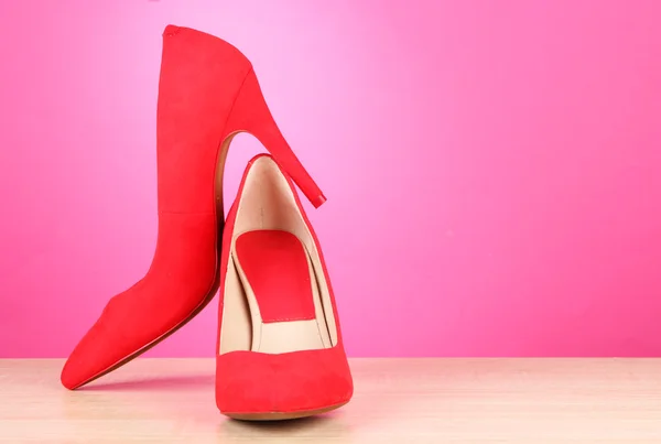 Beautiful red female shoes, on pink background — Stock Photo, Image