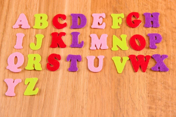 English alphabet on wooden background — Stock Photo, Image