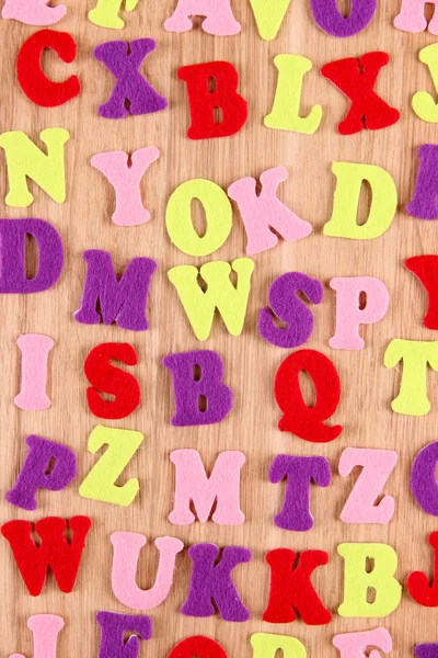 Alfabeto inglés sobre fondo de madera — Foto de Stock